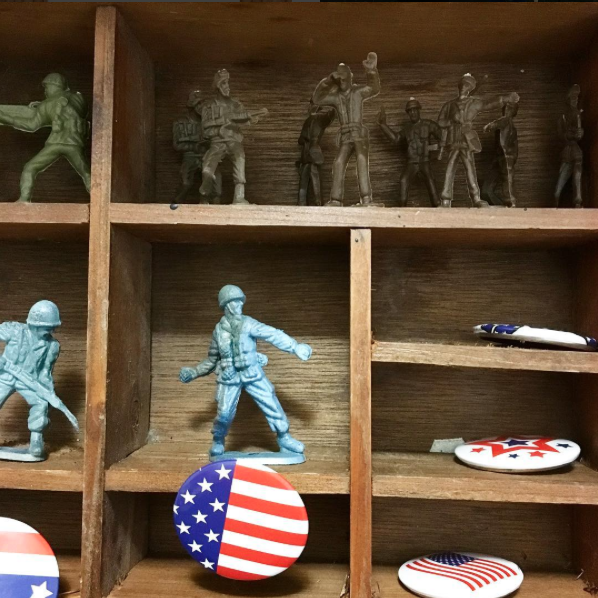 A picture of a shelf with USA army toy figures